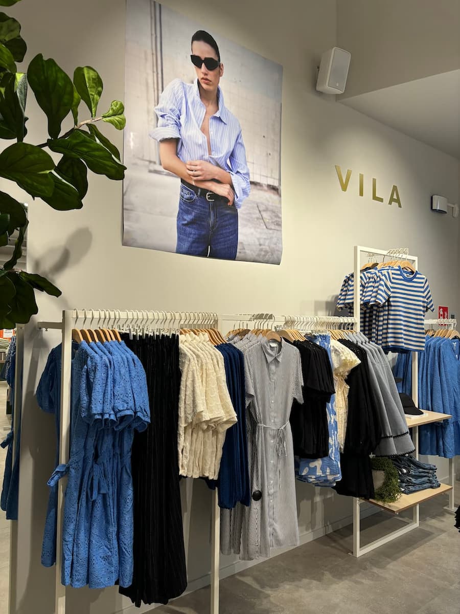 VILA Amsterdam. Photo and logo above clothes racks